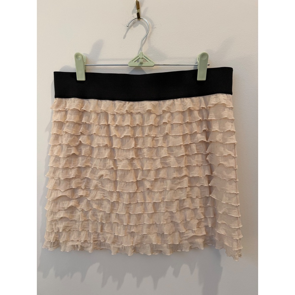Medium Free People beige ruffle mini skirt thick black elastic waistband.